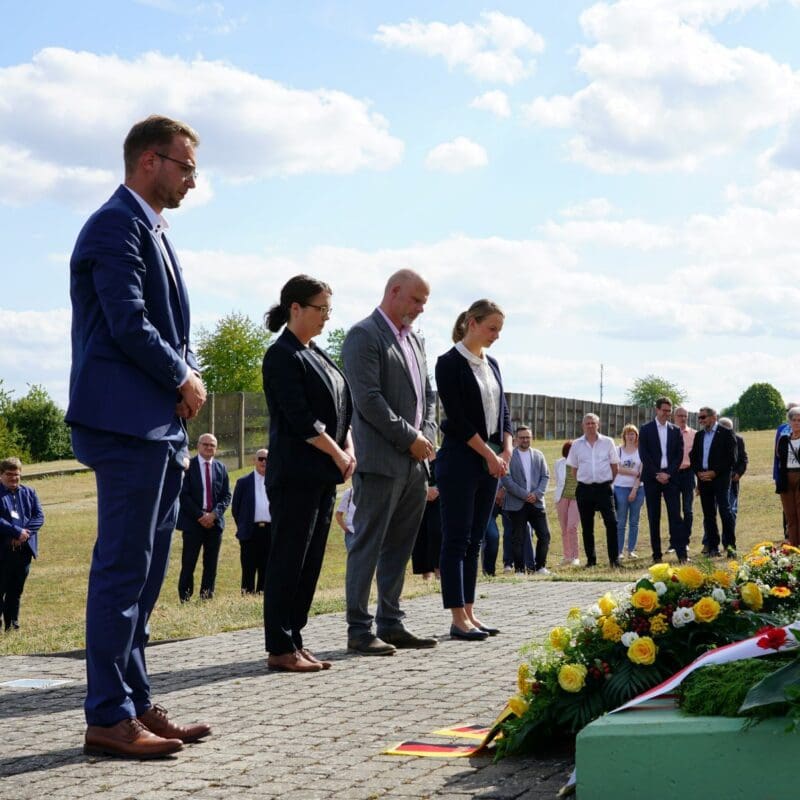 „Die Grenzabriegelung der DDR vor 70 Jahren“: Kranzniederlegung am Denkmal der deutschen Teilung und Wiedervereinigung mit (vorne von rechts) Tina Beer, Dr. Peter Wurschi, Dr. Franziska Kuschel und Benedikt Stock.